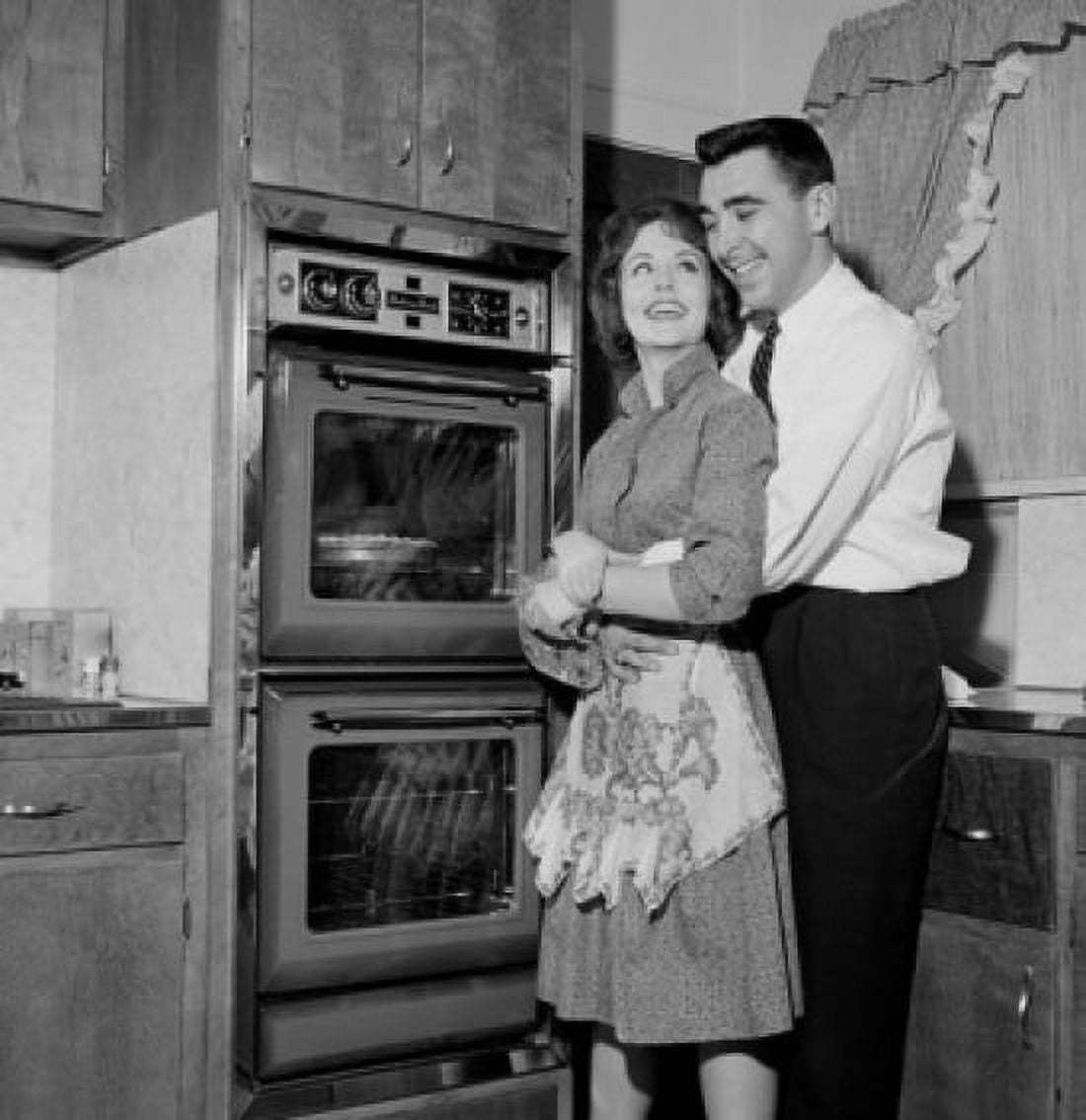 Happy couple in domestic kitchen Canvas Art - (24 x 36)
