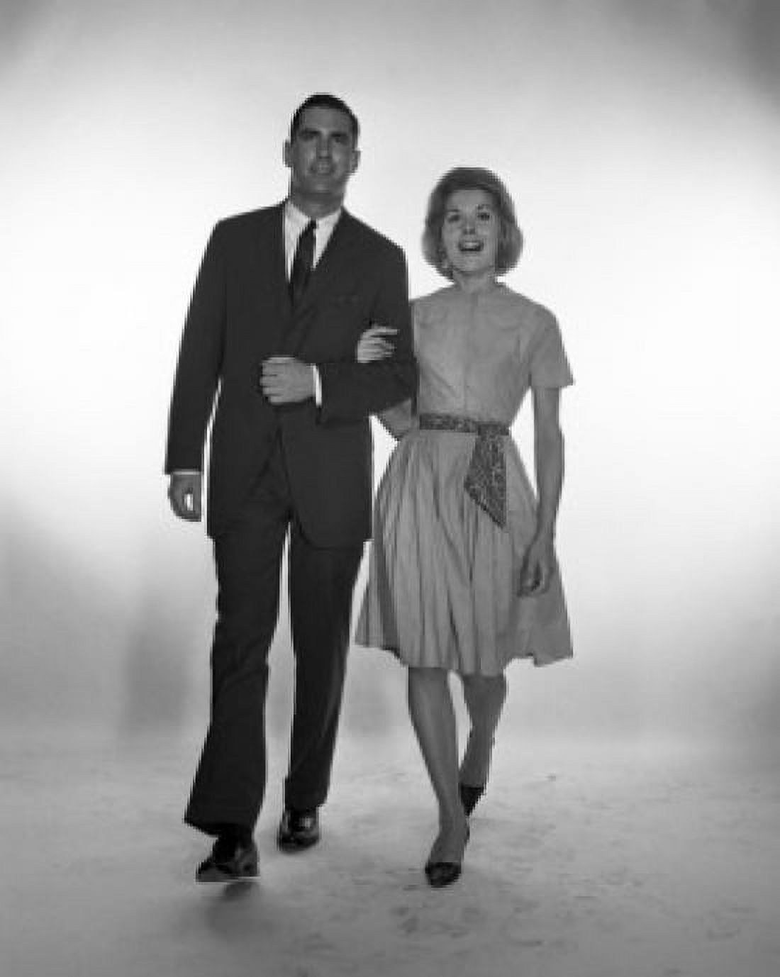 Happy mid adult couple walking studio shot Canvas Art - (24 x 36)