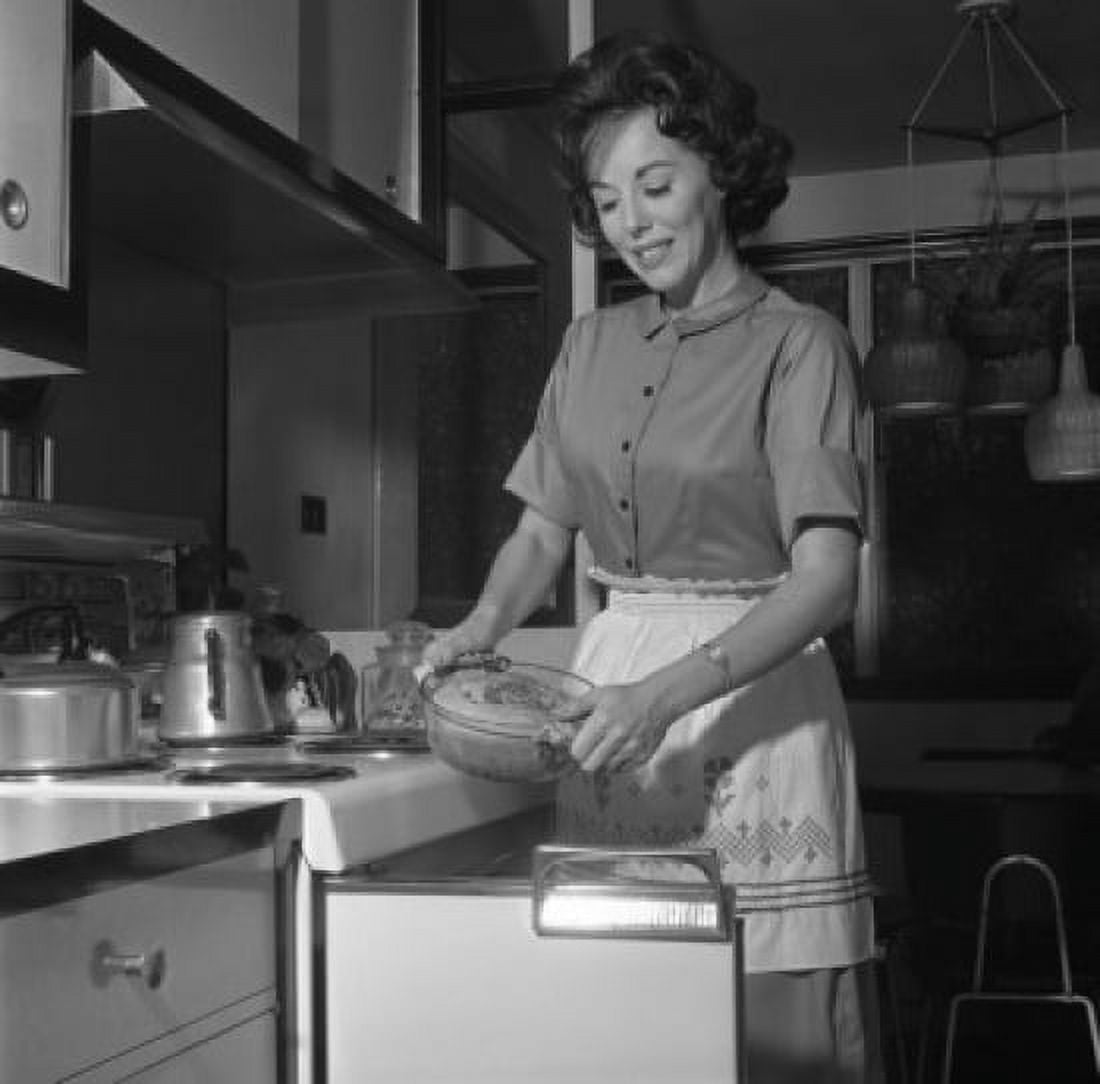 Happy woman putting meal into oven Canvas Art - (24 x 36)