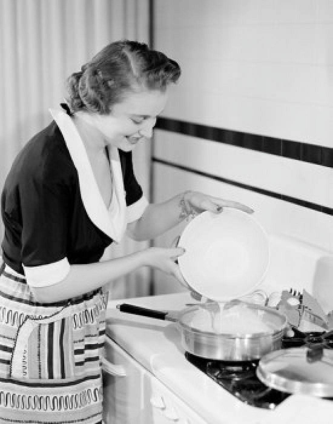 Happy young woman making omelet Canvas Art - (18 x 24)
