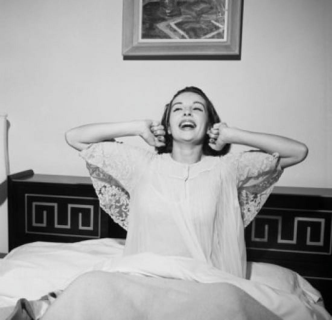 Happy young woman stretching in bed Canvas Art - (24 x 36)
