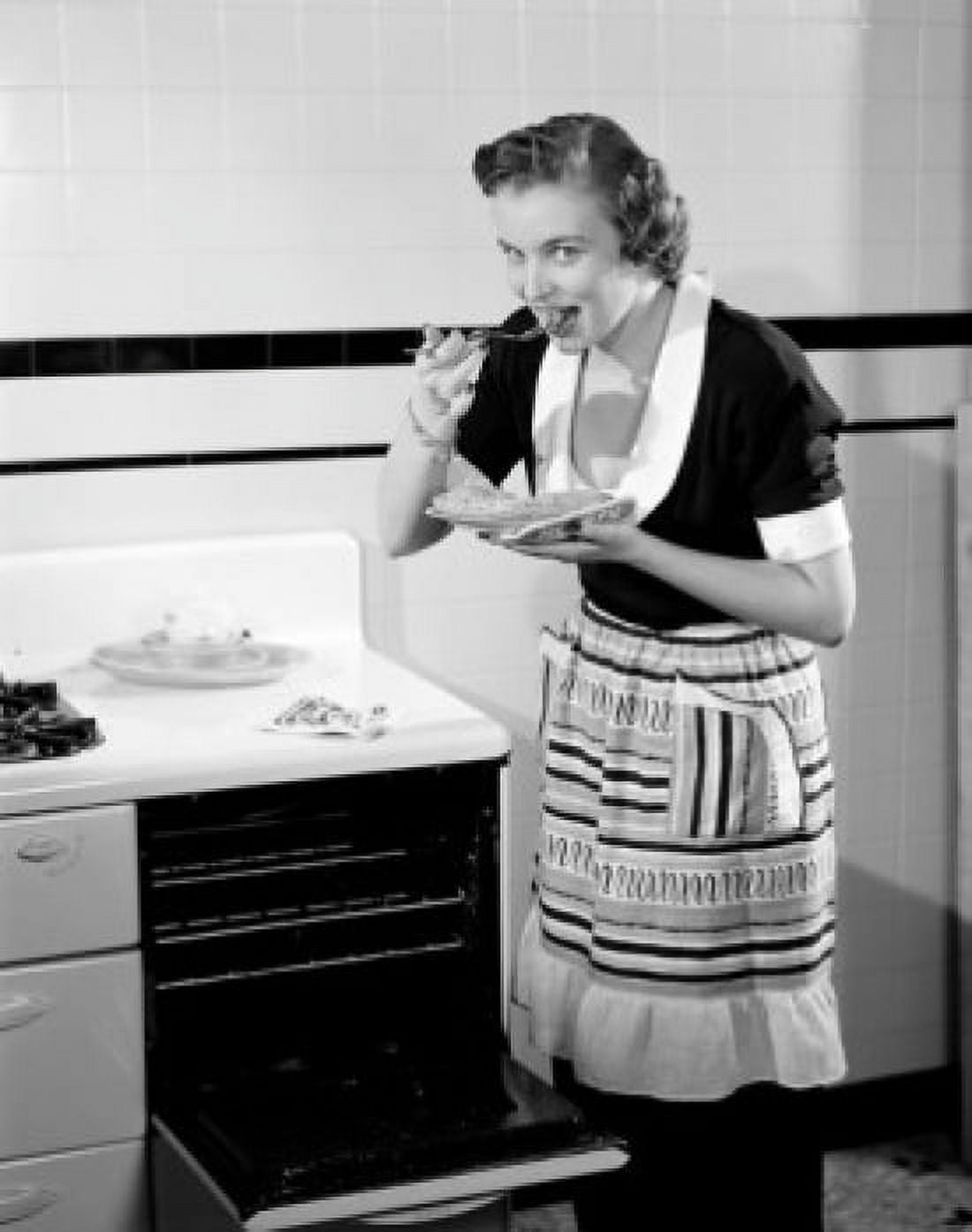Happy young woman trying freshly baked pie Canvas Art - (18 x 24)