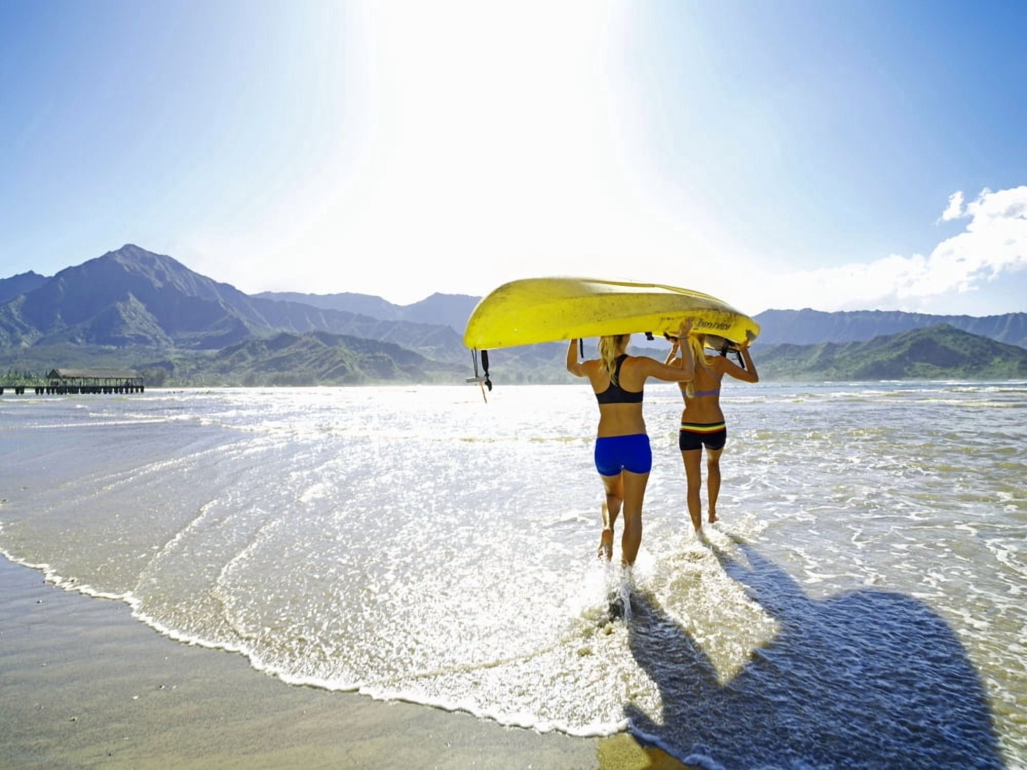 Hawaii Kauai Hanalei Bay Two Active Young Woman Carrying A Kayak Into The Ocean Canvas Art - Kicka Witte Design Pics (18 x 13)
