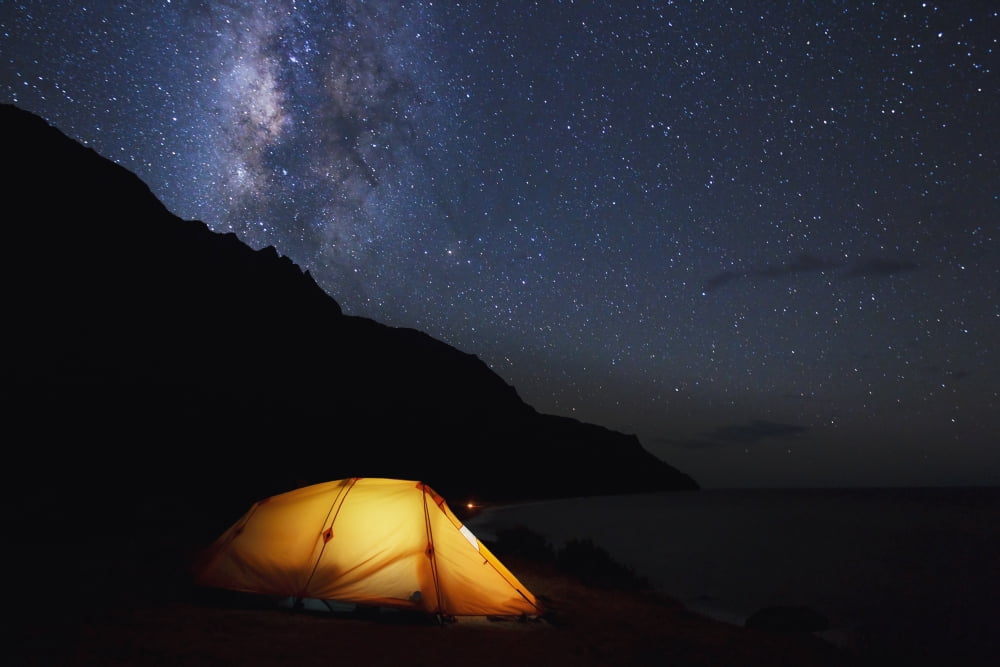 Hawaii Kauai Na Pali Coastline and Kalalau Mountains Iluminated tent and star filled sky Canvas Art - MakenaStockMedia Design Pics (19 x 12)