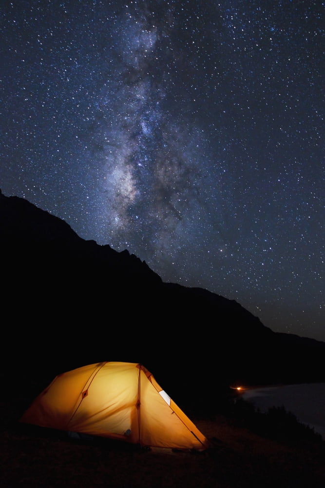 Hawaii Kauai Na Pali Coastline and Kalalau Mountains Ilumminated tent and star filled sky Canvas Art - MakenaStockMedia Design Pics (24 x 38)