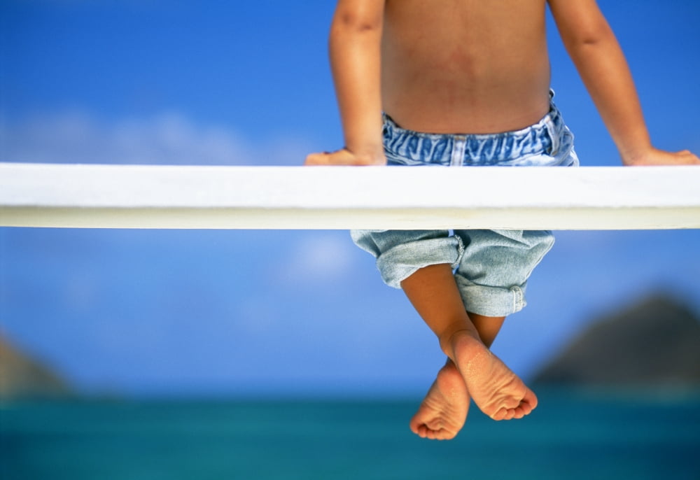 Hawaii Legs And Feet Of Young Boy Sitting On A Bench By The Ocean Canvas Art - Dana Edmunds Design Pics (36 x 24)