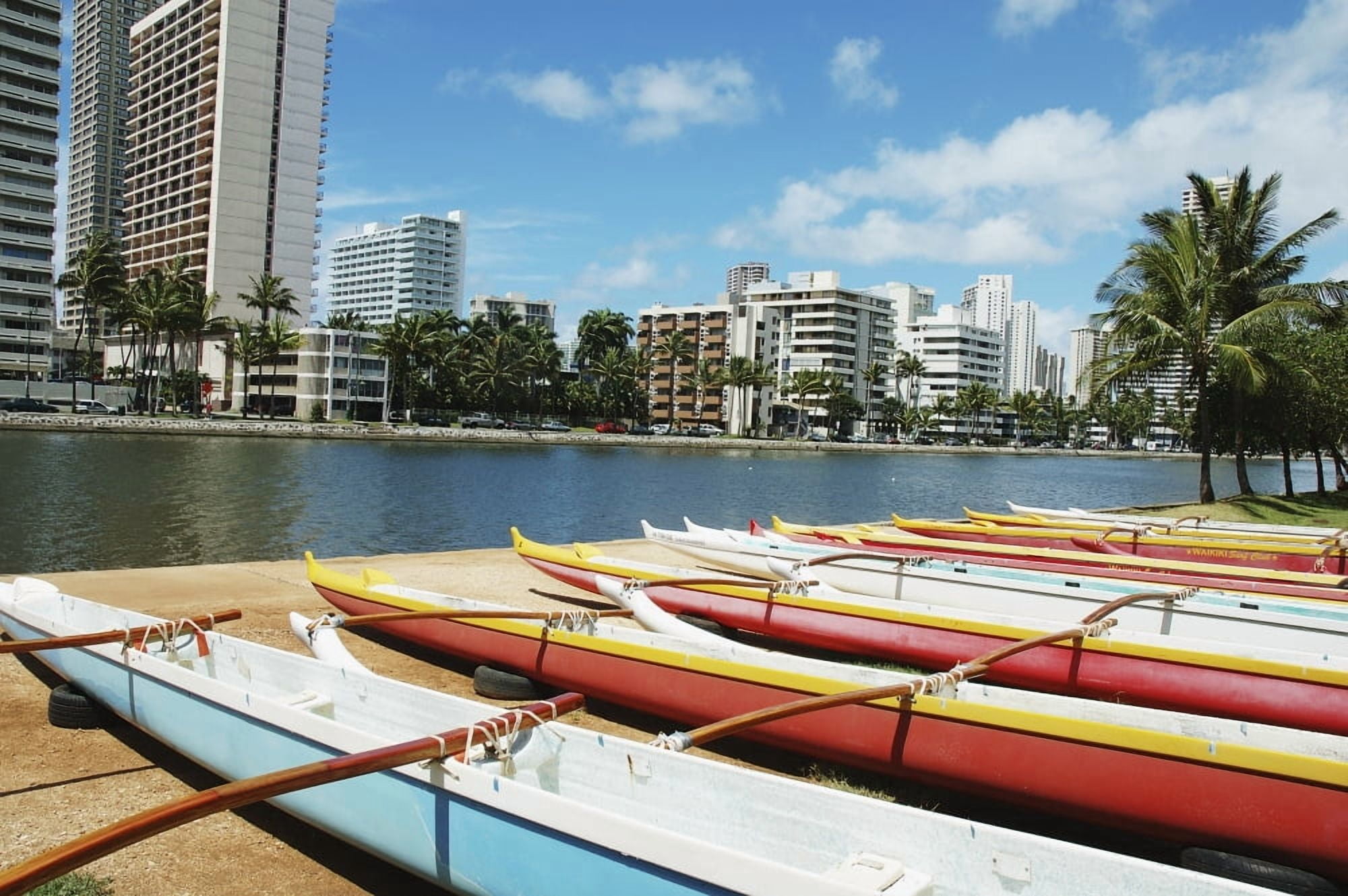Hawaii Oahu Honolulu Lineup Of Colorful Outrigger Canoes Next To Ala Wai Canal Waikiki Buildings Across The Water Canvas Art - Mary Van de Ven Design Pics (34 x 22)