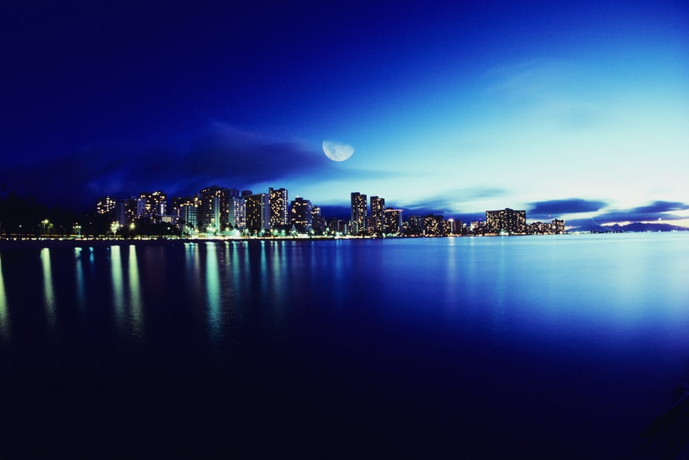 Hawaii Oahu Honolulu Waikiki skyline at night moon overhead view from ocean Canvas Art - Carl Shaneff Design Pics (17 x 11)