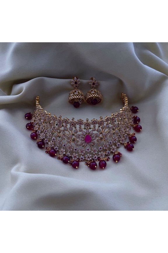 Haya Jewel South Indian Bollywood Gold-Plated Royal Leaf & Flower Nakshi Choker Necklace Set with Ruby, Green & White Kemp Stones, Maroon Pearl Guttapusalu, Jhumki Earrings & Maangtikka