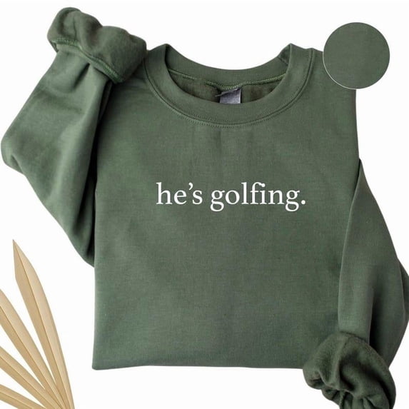He’s Golfing Sweatshirt – Funny Golfer Wife Crewneck – Golf Season Sweater for Moms – Unisex Fleece Gift for Golf Lovers