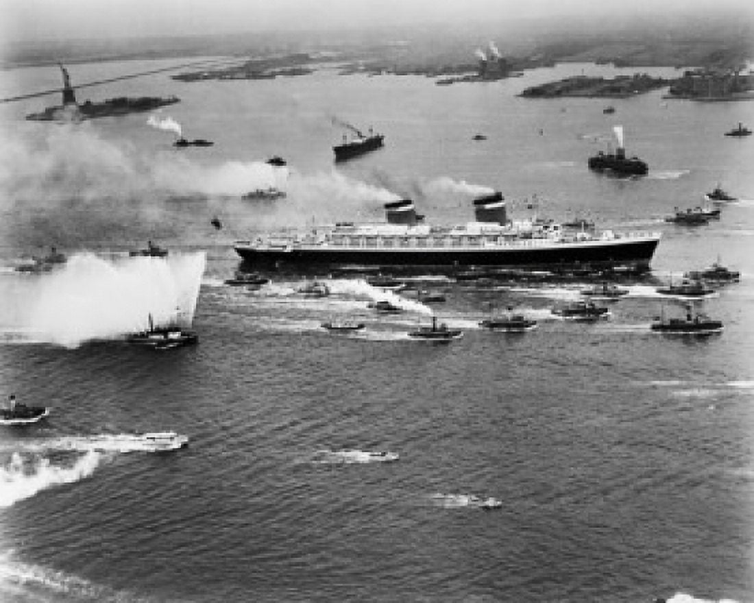 High angle view of a military ship and fireboats in the sea, SS United