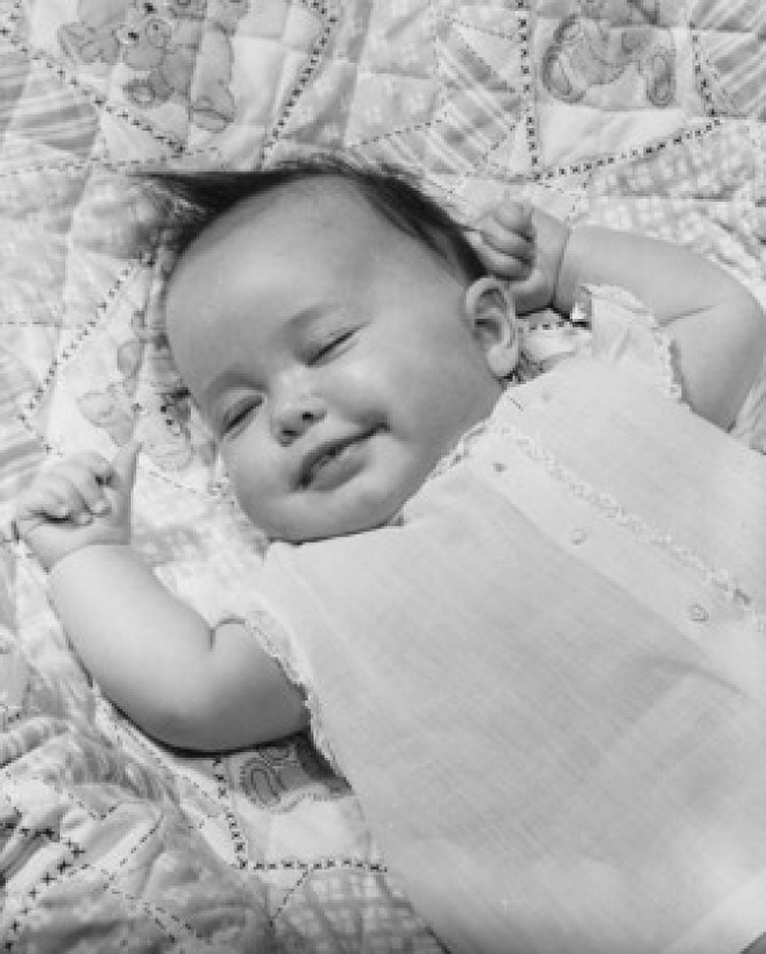 High angle view of a baby girl smiling and sleeping Canvas Art - (24 x 36)