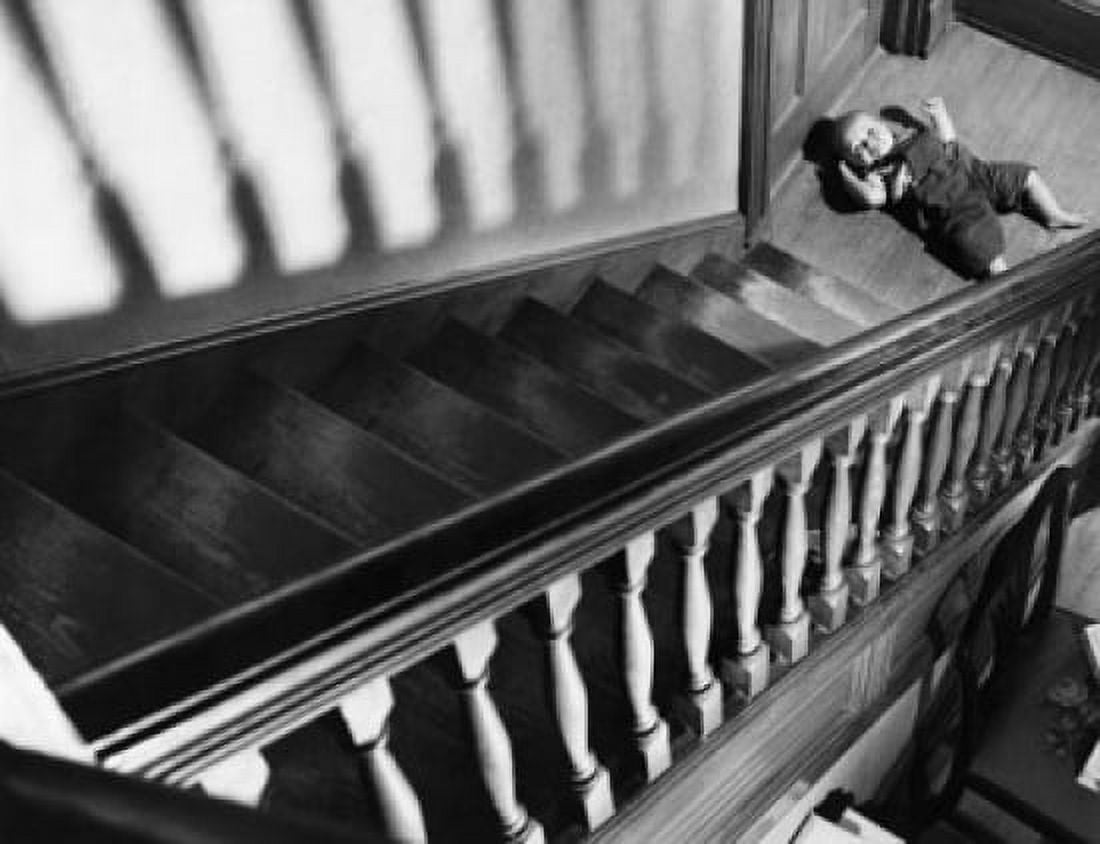 High angle view of a baby lying near a staircase Canvas Art - (18 x 24)