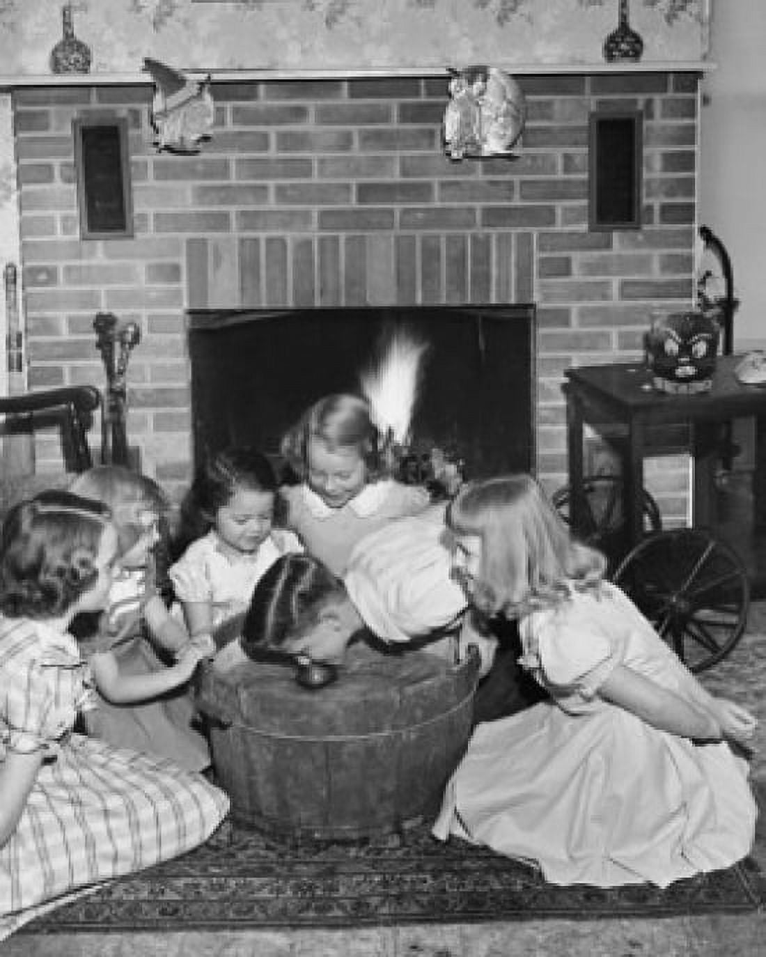 High angle view of a boy bobbing for apples with girls around him Canvas Art - (18 x 24)