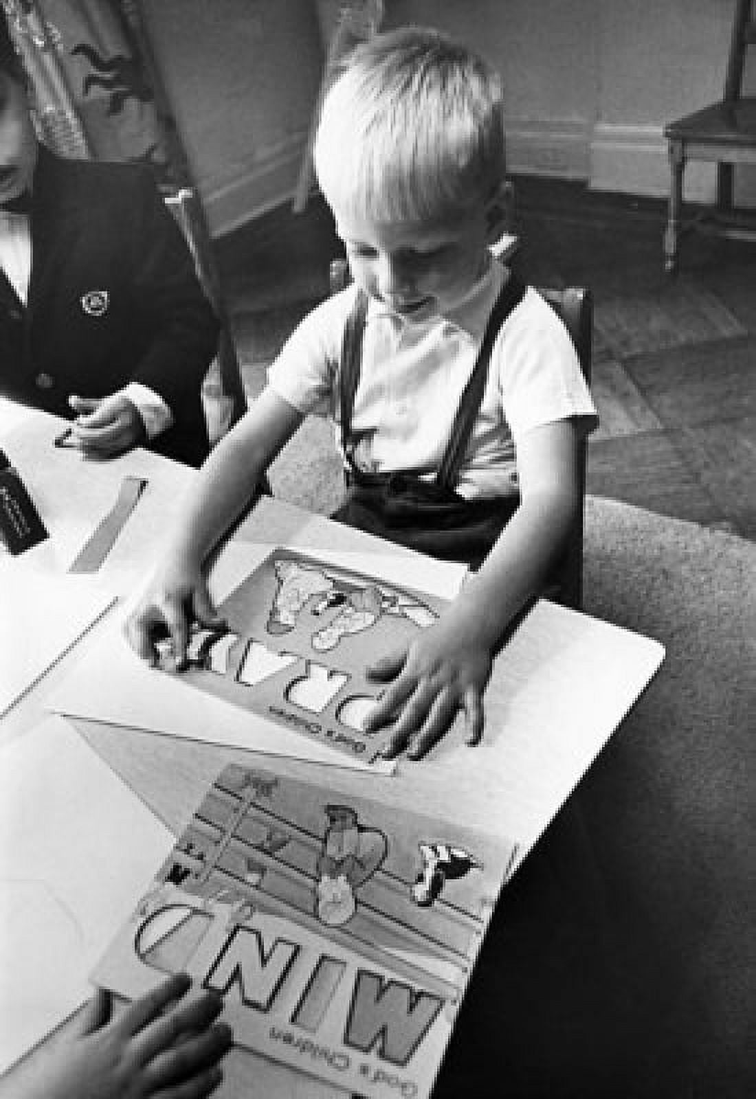High angle view of a boy playing with stencils Canvas Art - (18 x 24)