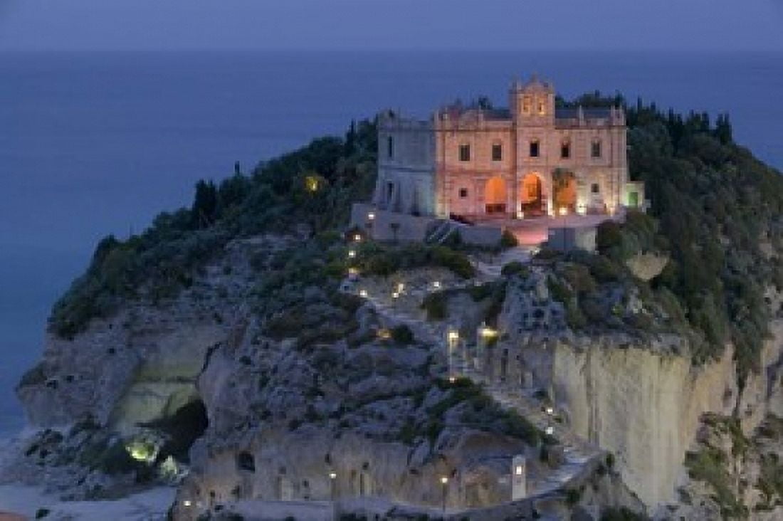 High angle view of a church lit up at dusk on a cliff Santa Maria dell Isola Tropea Calabria Italy Canvas Art - Panoramic Images (16 x 11)