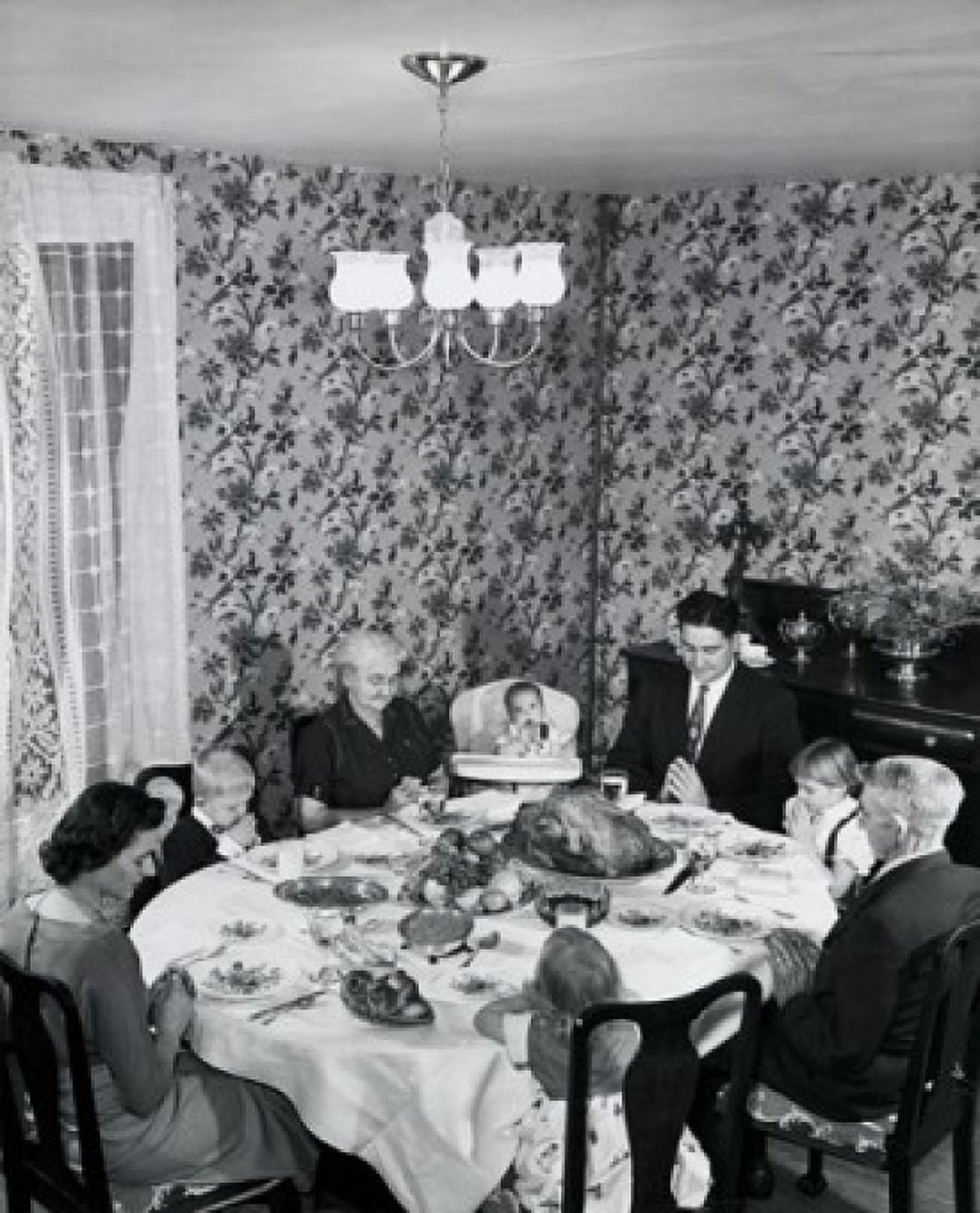 High angle view of a family praying at a dining table on Thanksgiving Day Canvas Art - (18 x 24)