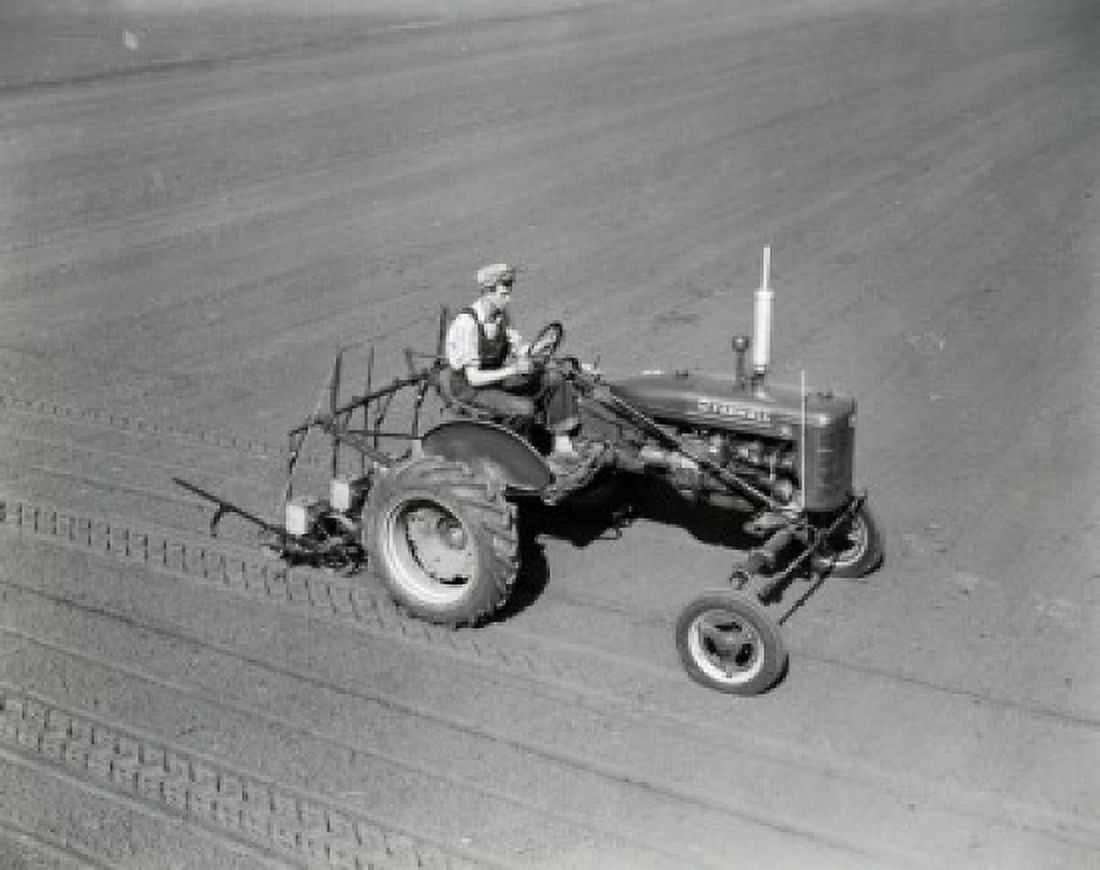 High angle view of a farmer plowing a field with a tractor Canvas Art - (24 x 36)