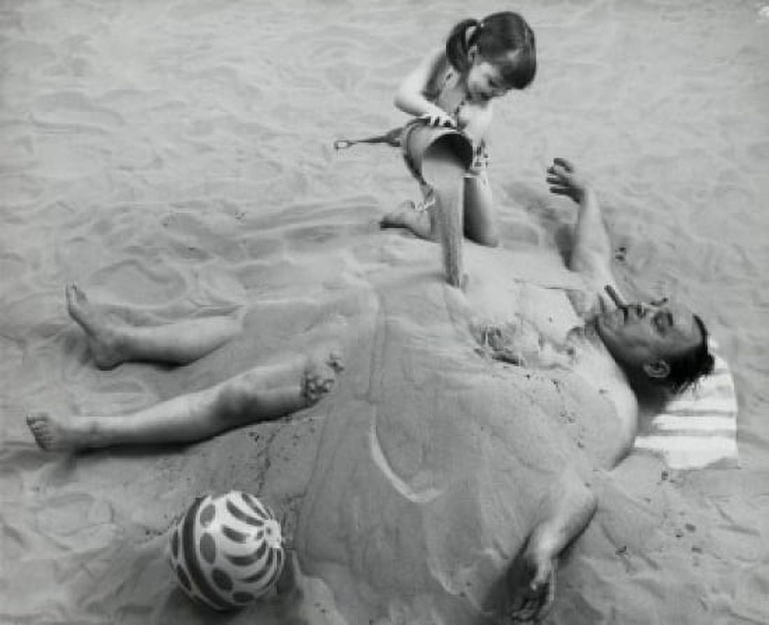 High angle view of a girl burying her father in sand on the beach Canvas Art - (18 x 24)