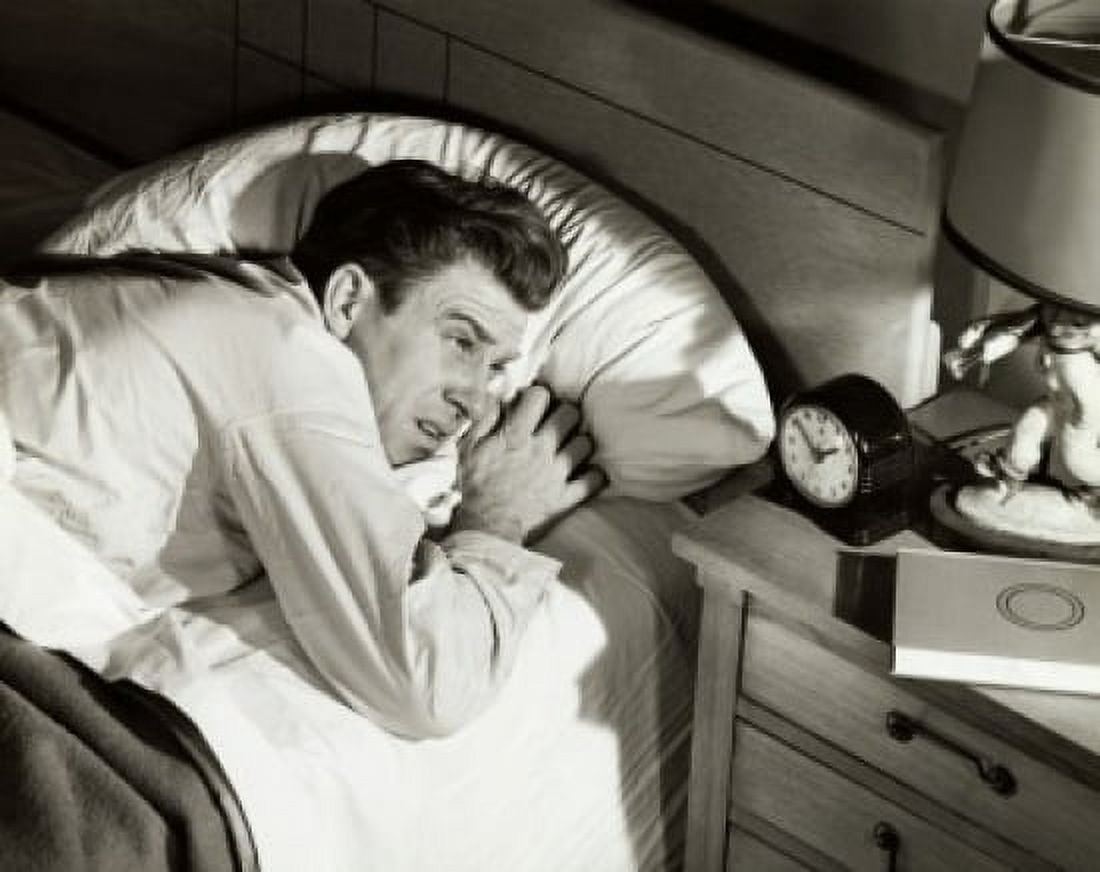 High angle view of a mid adult man lying on the bed Canvas Art - (24 x 36)