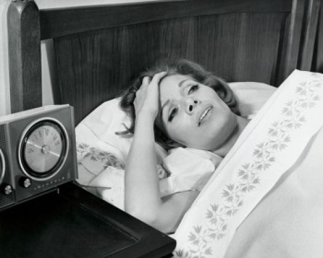High angle view of a mid adult woman lying in bed suffering from a headache Canvas Art - (18 x 24)
