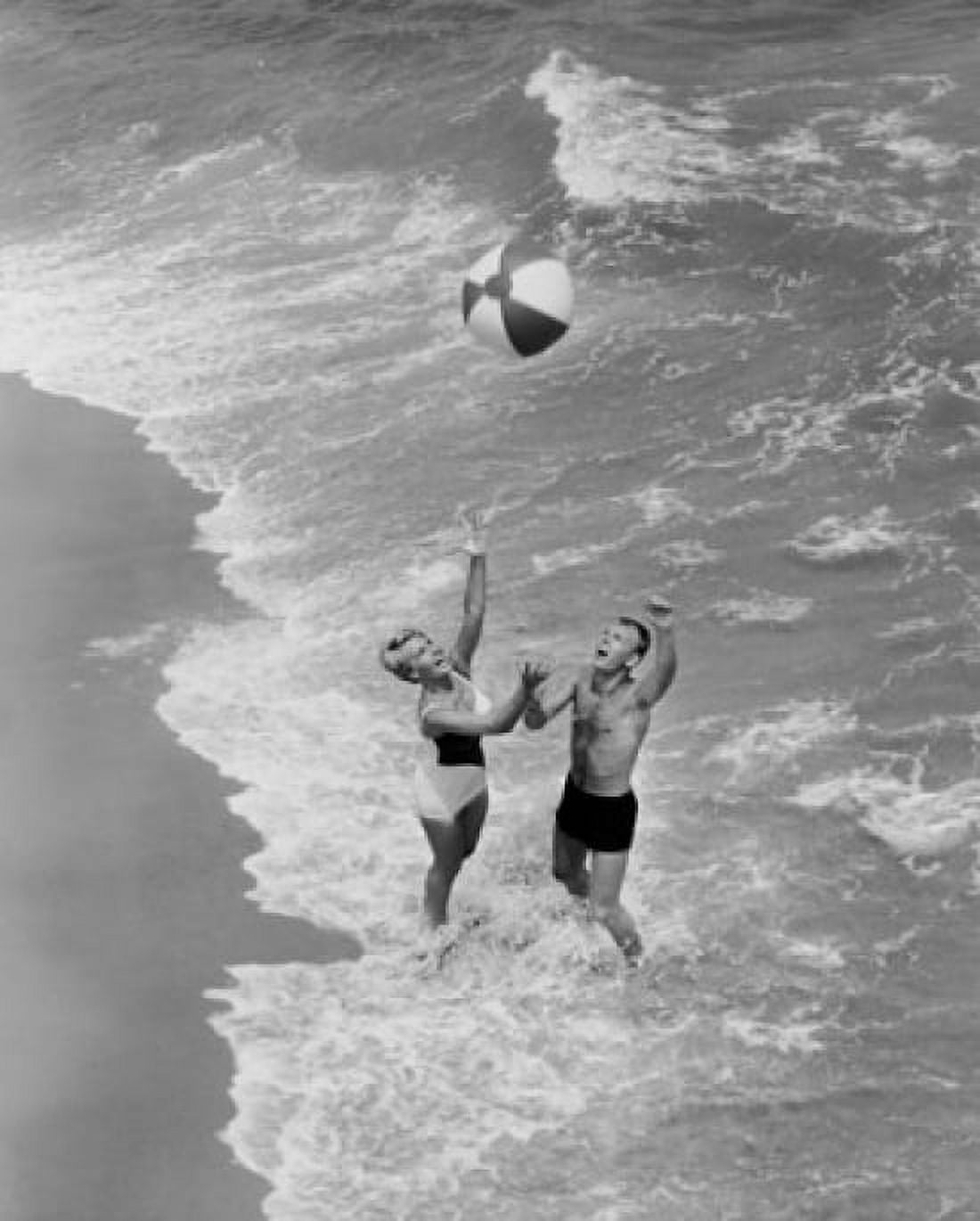High angle view of a young couple playing with a beach ball on the beach Canvas Art - (18 x 24)