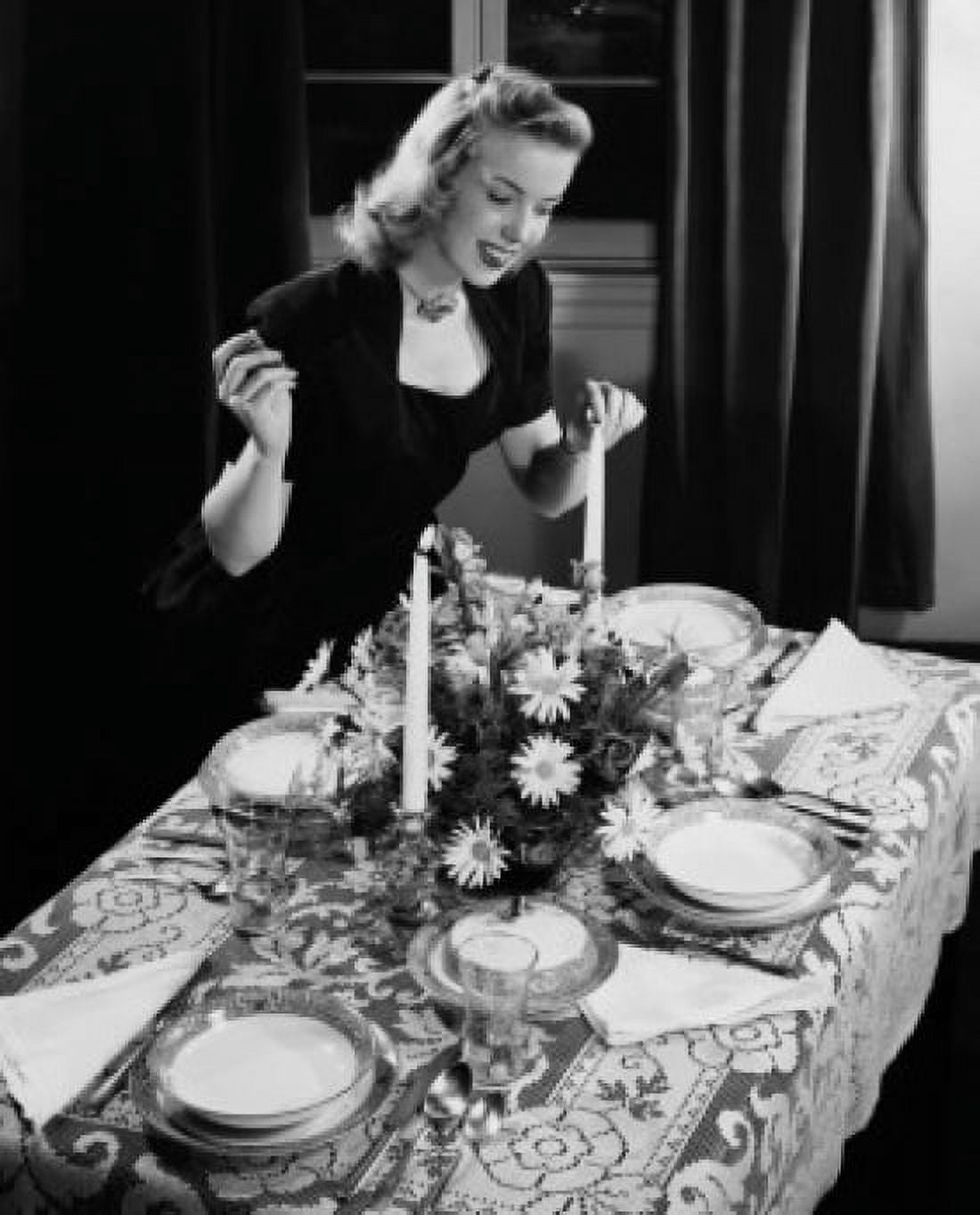 High angle view of a young woman lighting a candle on a dining table Canvas Art - (18 x 24)