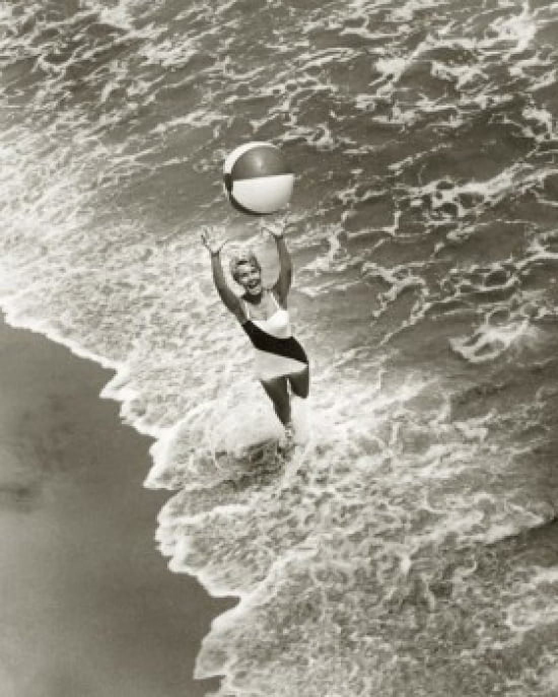 High angle view of a young woman playing with a beach ball on the beach Canvas Art - (24 x 36)