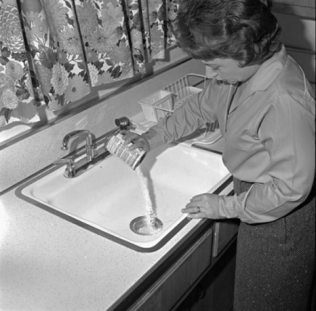 High angle view of a young woman pouring drain cleaner into a sink Canvas Art -  (24 x 36)