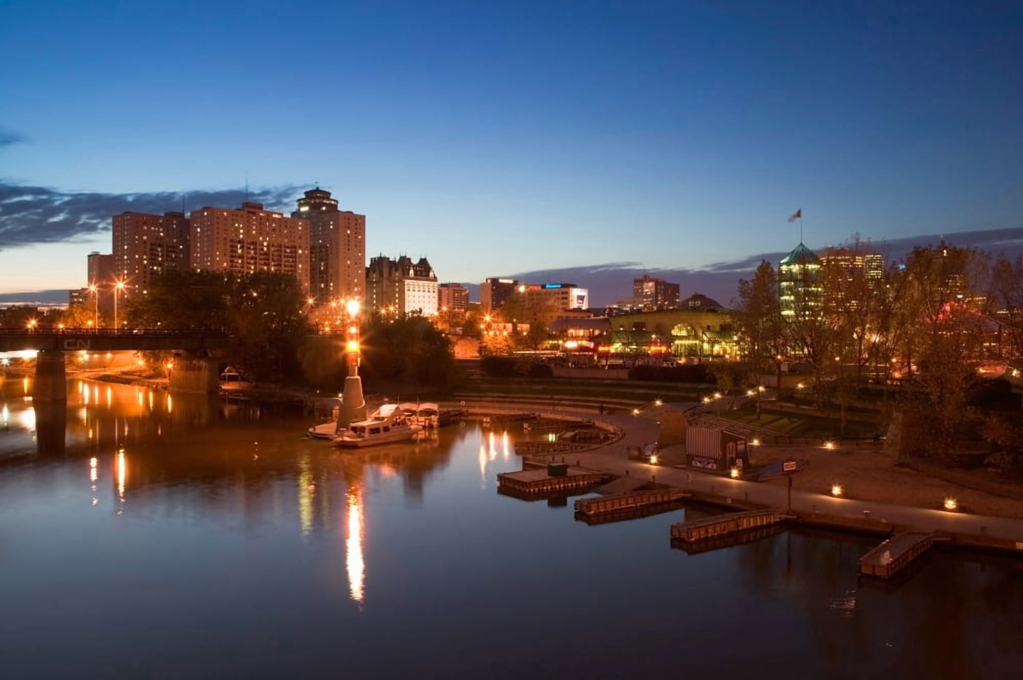 High angle view of buildings lit up at dusk Winnipeg Manitoba Canada Canvas Art - Panoramic Images (27 x 9)