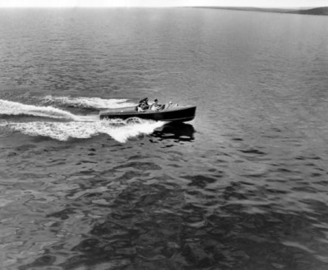 High angle view of four people in a motorboat Canvas Art - (18 x 24)