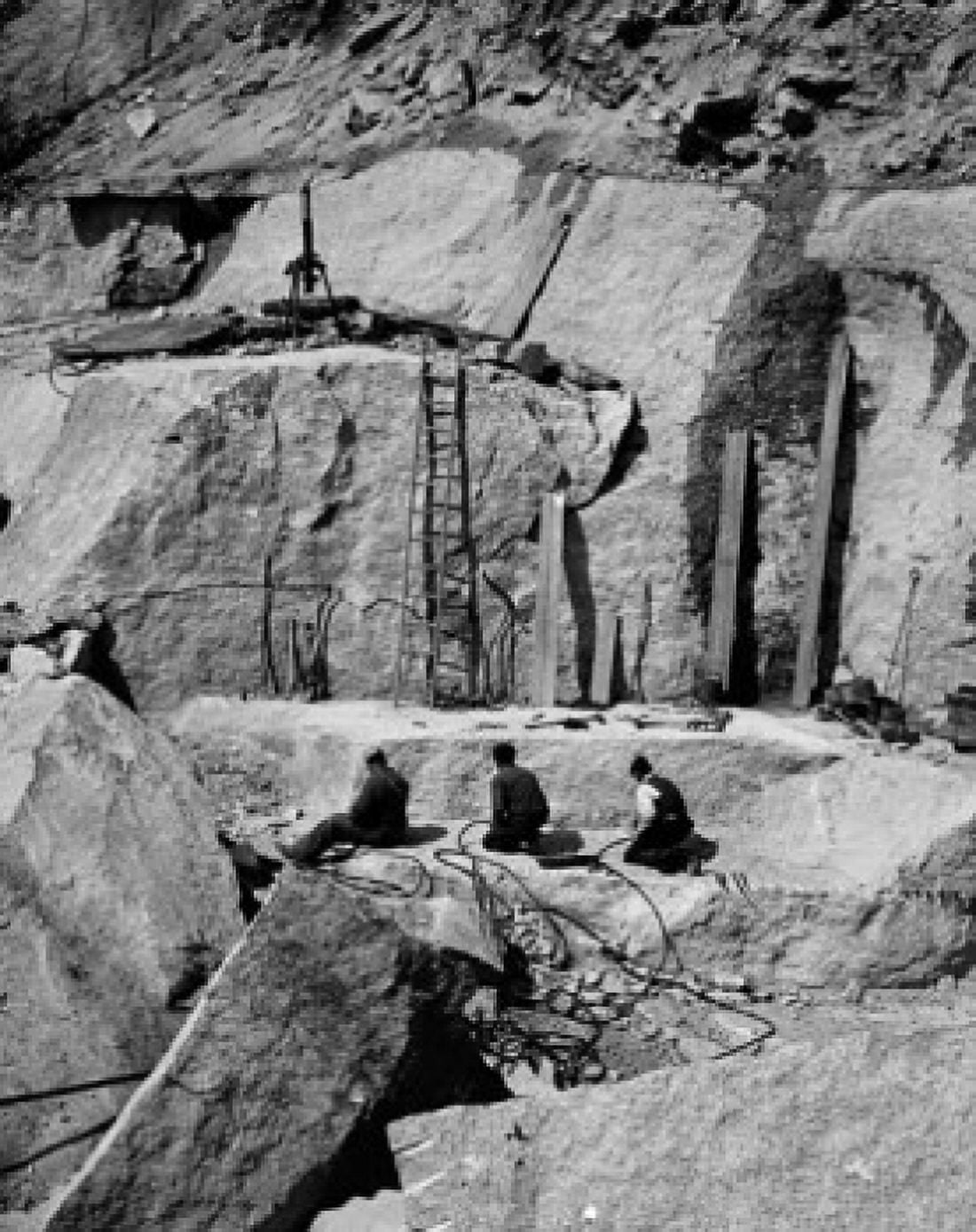 High angle view of three people sitting at granite quarry Canvas Art - (18 x 24)