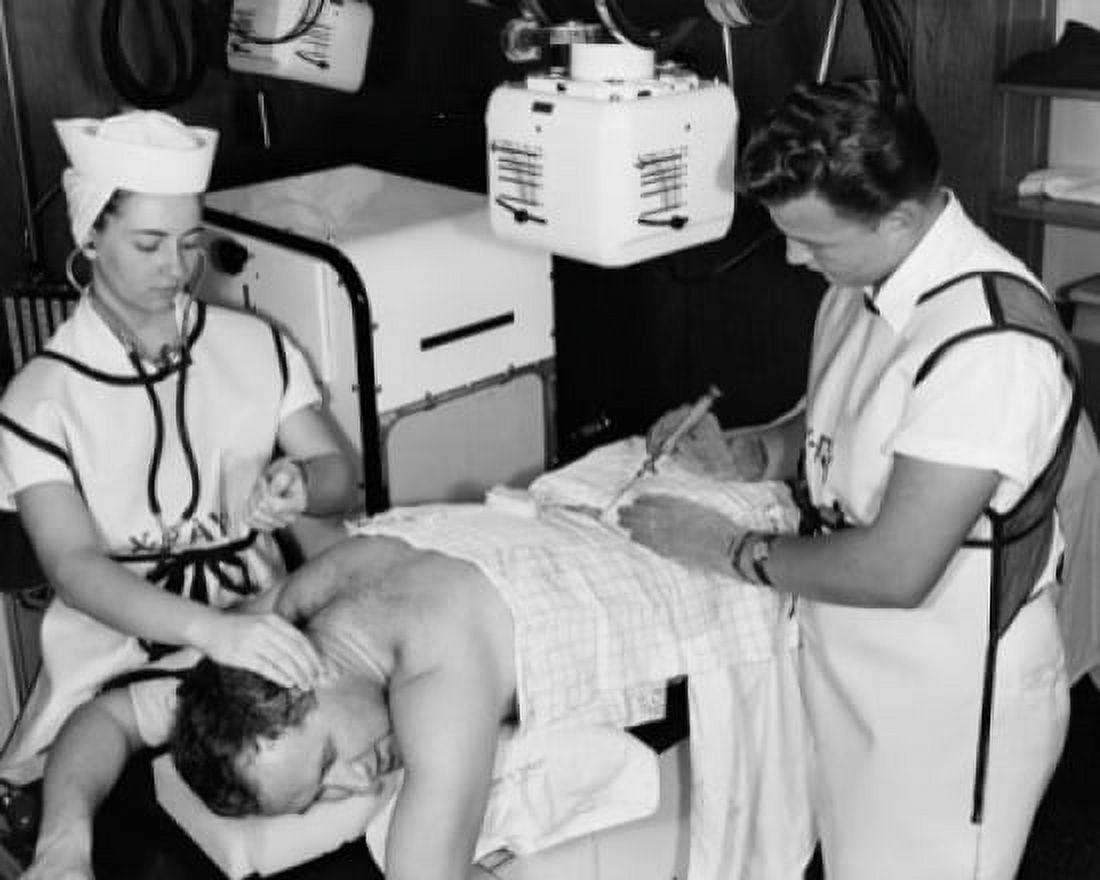 High angle view of two radiologists taking an x-ray of a patients back Canvas Art - (24 x 36)