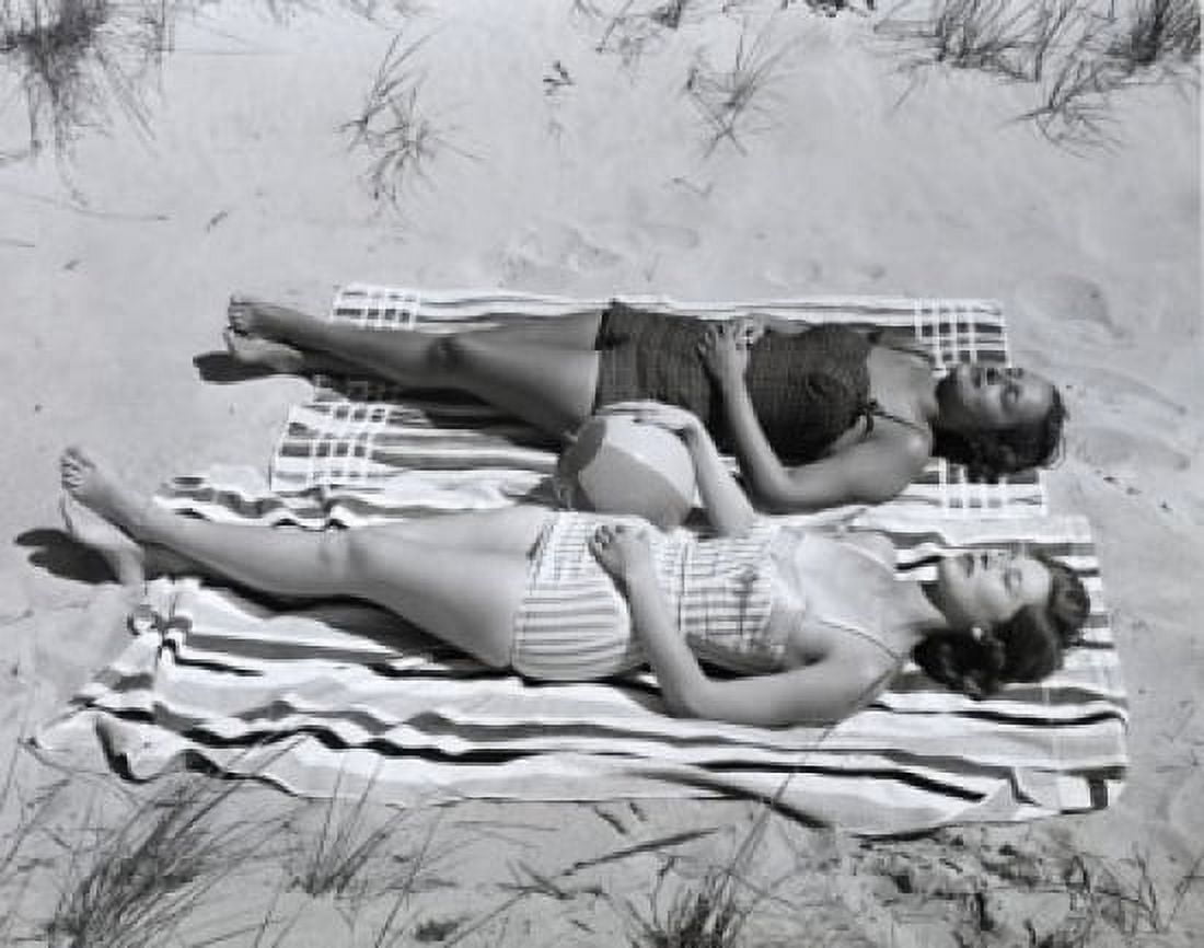 High angle view of two young women sunbathing on beach Canvas Art - (24 x 36)