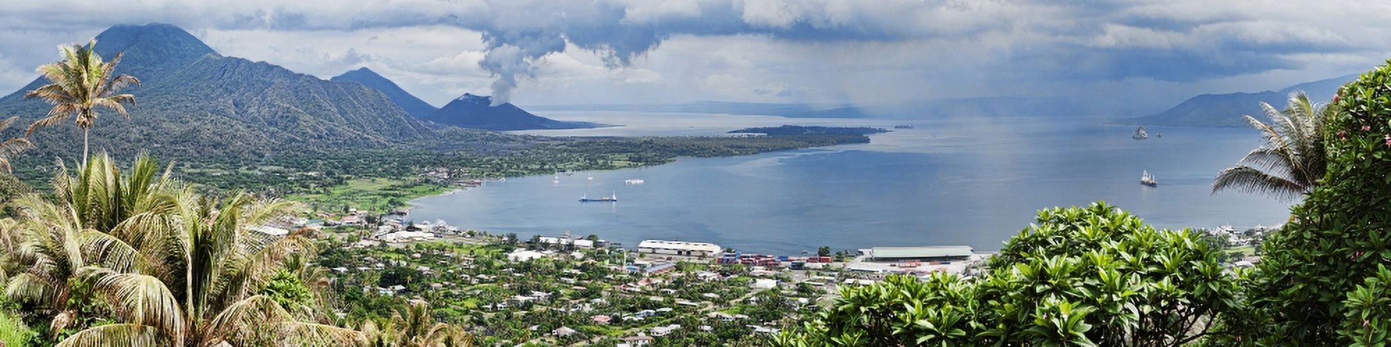 High angle view of a town on the coast with volcano in the background Tavurvur Rabaul East New Britain Papua New Guinea Canvas Art - Panoramic Images (36 x 9)