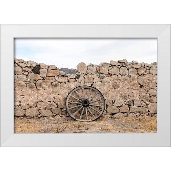 Highmith, Carol 14x11 White Modern Wood Framed Museum Art Print Titled - Wagon wheel against a stone fence at Hueco Tanks State Park, northwest of El Paso, TX