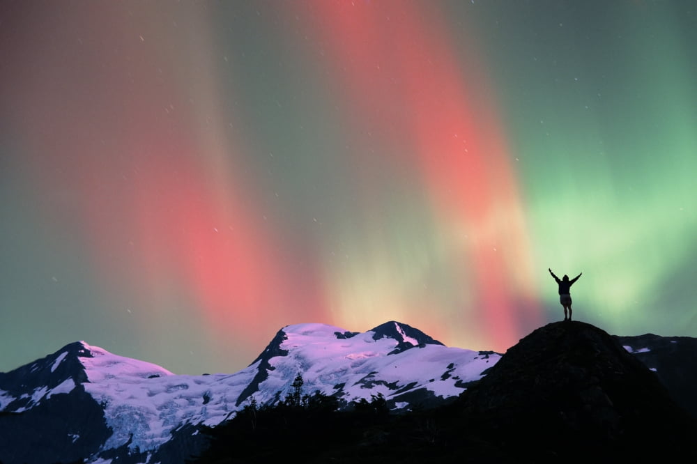 Hiker Praises N Lights Over Portage Pass Composite Sc Ak Canvas Art - Michael DeYoung Design Pics (19 x 12)