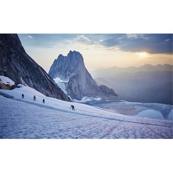 Hiking around a crevice of West Ridge of Pigeon Spire route in the Bugaboos Provincial Park at dawn; British Columbia C