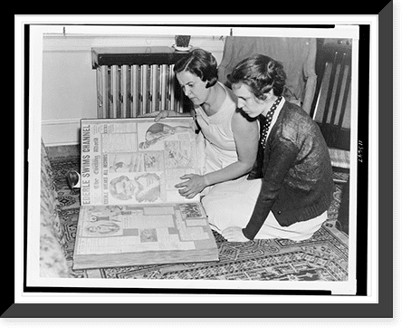 Historic Framed Print, [Gertrude Ederle and another woman sitting on floor looking at scrapbook ...