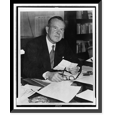 thumbnail image 1 of Historic Framed Print, [Lester Pearson, half-length portrait, seated at desk, facing slightly right, holding up radiogram], 17-7/8" x 21-7/8", 1 of 9