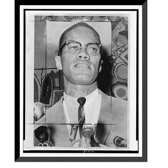 Historic Framed Print, [Malcolm X, head-and-shoulders portrait, facing slightly right, at microphones].World Telegram & Sun photo by Ed Ford., 17-7/8" x 21-7/8"