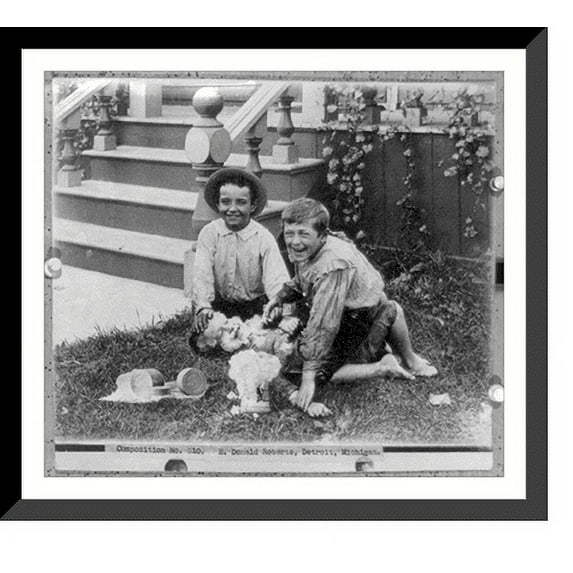 Historic Framed Print, Two boys holding down another boy on lawn, and putting J.B. Williams & Co.'s barbers soap on his face, 17-7/8" x 21-7/8"