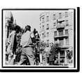 thumbnail image 1 of Historic Print, [American camera crew films Daniel L. Schorr, with notes in hand, standing in front of the American Legation in Freedom Square, Budapest, Hungary, for the program Hungar...18" x 24", 1 of 3