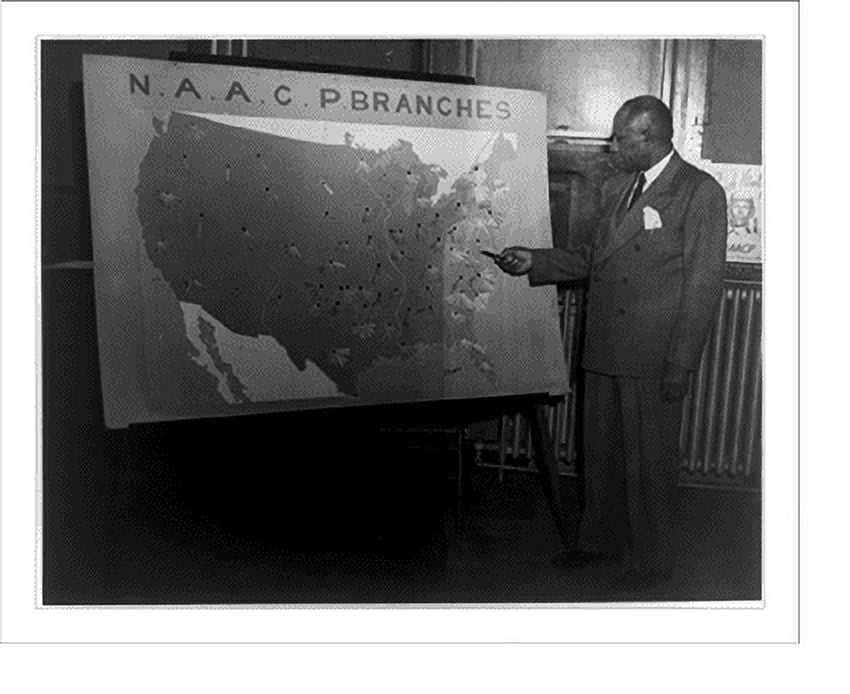 Historic Print, [Carl R. Johnson pointing to a map of the U.S. showing