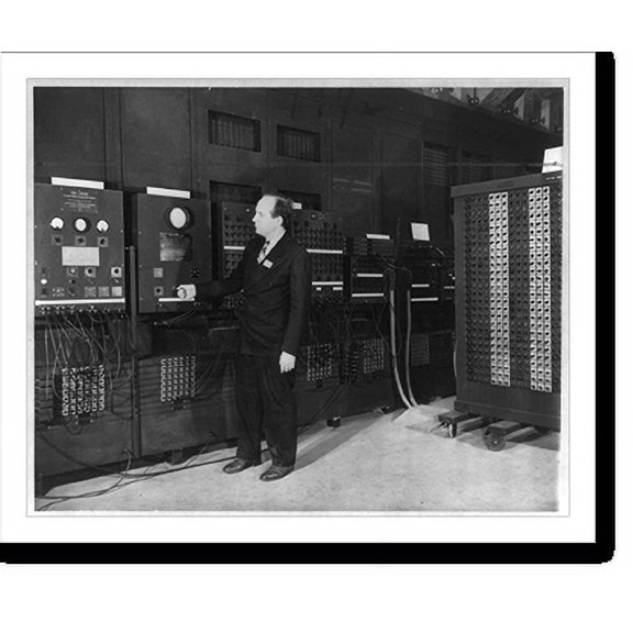 Historic Print, Co-inventor examines new calculator. Dr. J. Presper Eckert, Jr., co-inventor of the electronic numberical integrator and computer at the University of Pennsylvania here,...18" x 24"