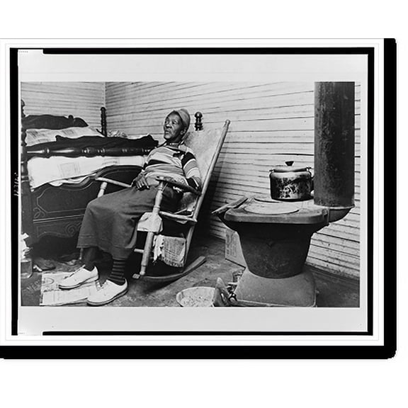 Historic Print, [Elderly African American woman seated on rocking chair, at foot of bed, next to stove, in North Carolina].Billy Barnes for the North Carolina Fund., 16" x 20"