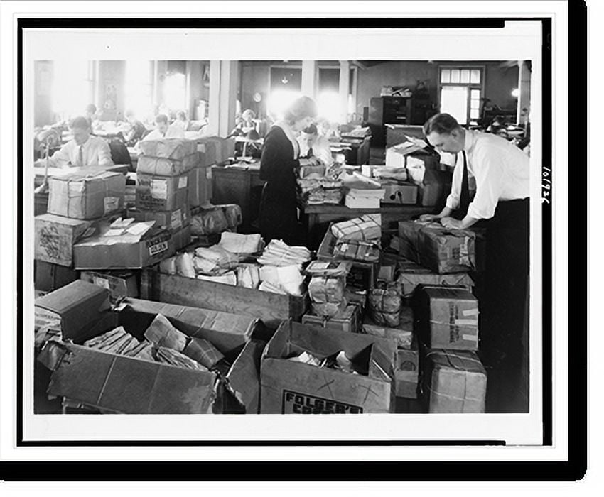 Historic Print, [Employees working on large load of relief vouchers in