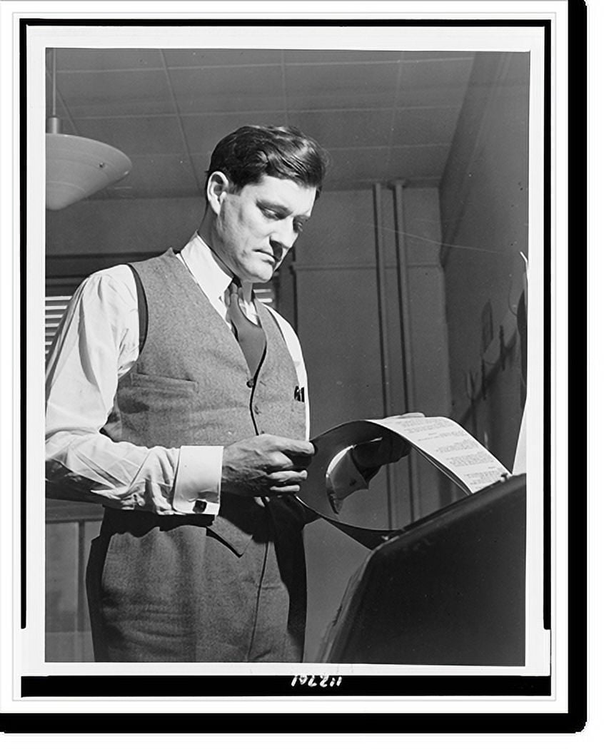 Historic Print, [Eric Sevareid reads document from teletype], 16" x 20