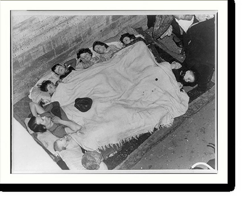 Historic Print, [Family of nine sleeping under one bedspread in an air