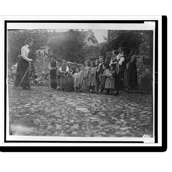 Historic Print, [Frances Benjamin Johnston photographing a group of people, mostly children, in Europe], 16" x 20"